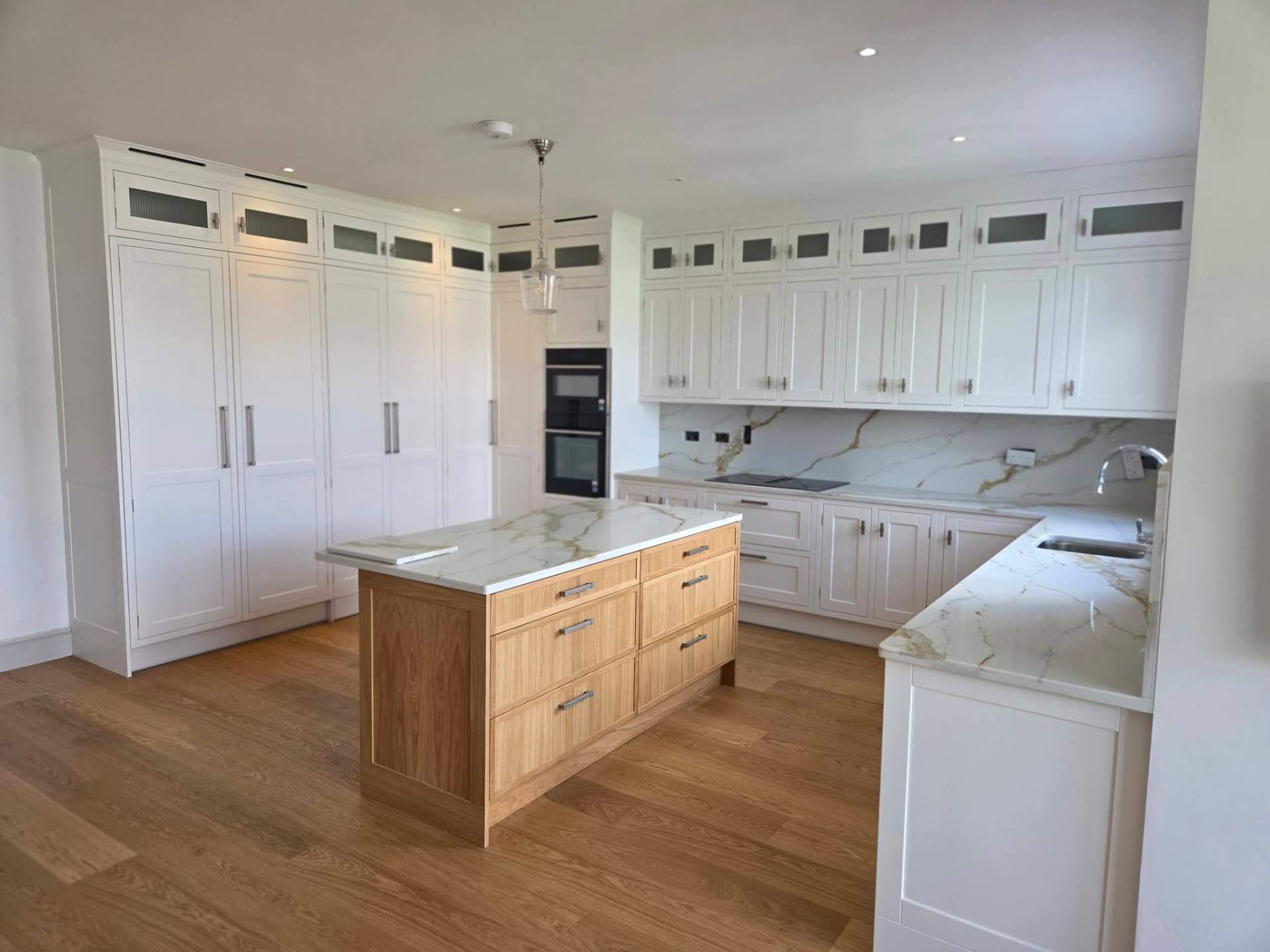 In-frame shaker kitchen in soft white and natural oak.